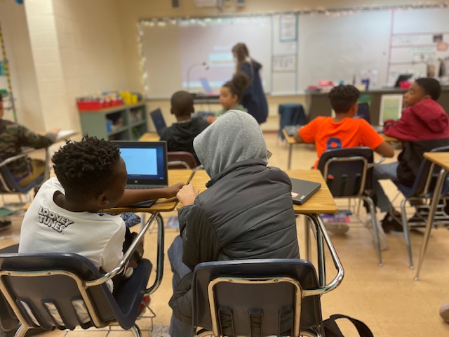 Students participating in a coding lesson